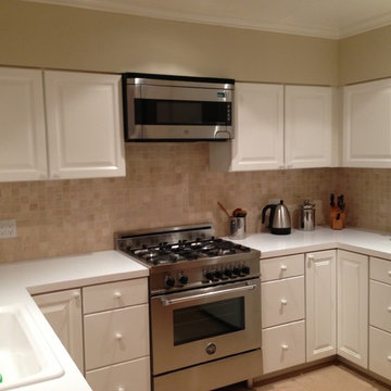 Contemporary cooks kitchen with limestone backsplash