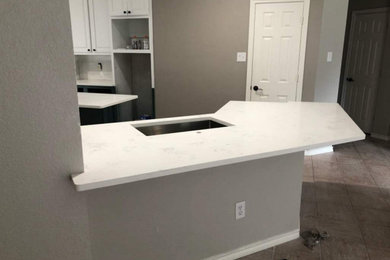 Eat-in kitchen - mid-sized contemporary u-shaped porcelain tile eat-in kitchen idea in Dallas with a single-bowl sink, raised-panel cabinets, blue cabinets, quartz countertops, an island and white countertops