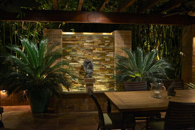 This is an example of a mid-sized traditional backyard patio in Orange County with a pergola.