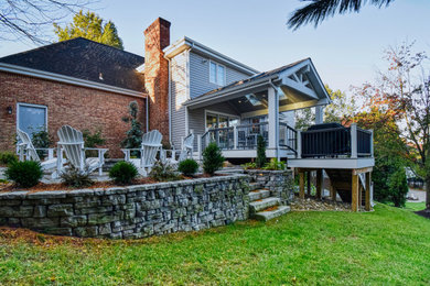 Inspiration for a mid-sized transitional backyard concrete paver patio remodel in Other with a fire pit and a roof extension