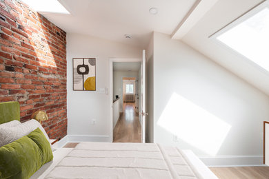 Example of a mid-sized trendy guest vinyl floor and beige floor bedroom design in DC Metro with white walls and no fireplace