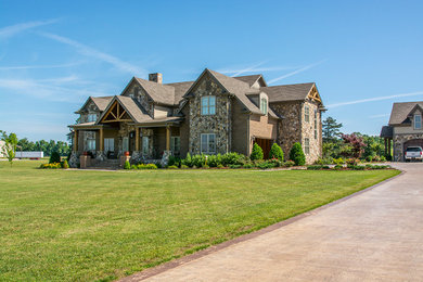 Example of a large mountain style brown two-story mixed siding house exterior design in Other with a hip roof and a shingle roof