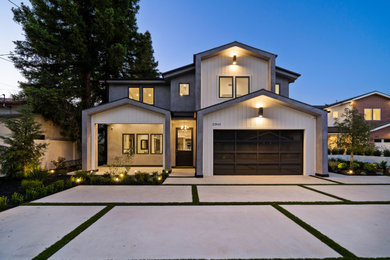 Inspiration for a large country two-storey stucco grey house exterior in Los Angeles.