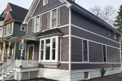 Inspiration for a large victorian gray two-story wood gable roof remodel in Chicago