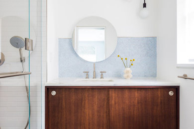Photo of a bathroom in New York with flat-panel cabinets, marble worktops, a single sink and a floating vanity unit.