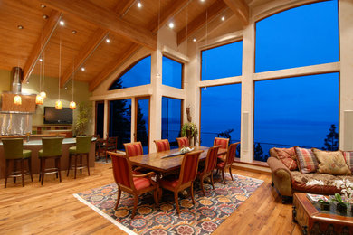 Inspiration for a large contemporary medium tone wood floor great room remodel in Other with green walls