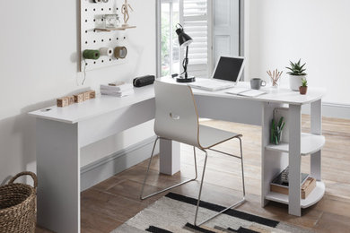 Photo of a medium sized modern home office in Oxfordshire with white walls, medium hardwood flooring and brown floors.