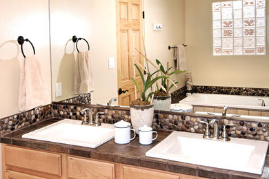 Mid-sized transitional master bathroom photo in Albuquerque with recessed-panel cabinets, light wood cabinets, a one-piece toilet, beige walls, a drop-in sink and a hinged shower door