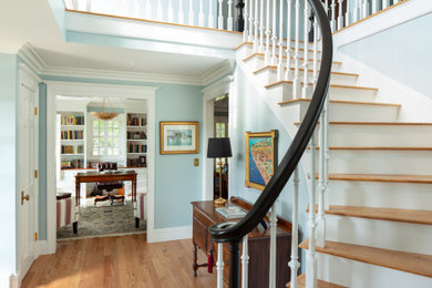 Inspiration for a timeless wooden curved wood railing staircase remodel in Boston with painted risers