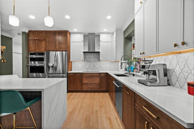 Eat-in kitchen - mid-sized light wood floor and wood ceiling eat-in kitchen idea in Seattle with a single-bowl sink, flat-panel cabinets, brown cabinets, marble countertops, white backsplash, porcelain backsplash, stainless steel appliances, a peninsula and white countertops