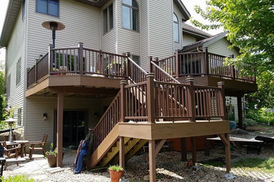 Example of a large classic backyard deck design in Other with no cover