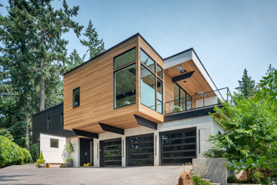 Huge contemporary two-story wood exterior home idea in Portland
