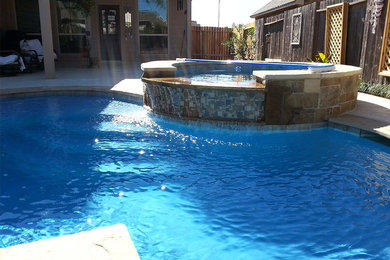Inspiration for a mid-sized backyard stamped concrete and custom-shaped natural hot tub remodel in Houston