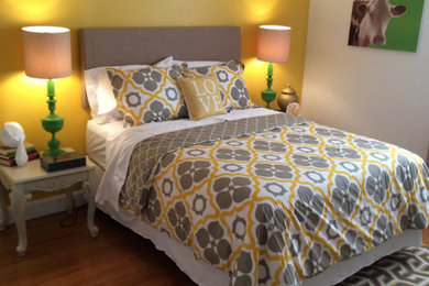 Bedroom - mid-sized transitional guest medium tone wood floor and brown floor bedroom idea in Nashville with yellow walls and no fireplace