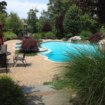 Custom Pools & Spas, Outdoor Kitchens, Patios & Walkways, and Plantings
