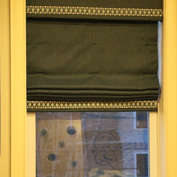 Cordless Roman shades with matching valance and trim detai