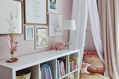 Inspiration for a mid-sized transitional girl carpeted and beige floor kids' room remodel in Other with pink walls