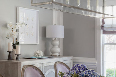 Inspiration for a mid-sized transitional medium tone wood floor and brown floor enclosed dining room remodel in New York with gray walls