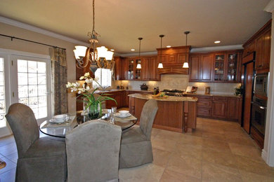 Kitchen - huge contemporary ceramic tile kitchen idea in St Louis with a double-bowl sink, raised-panel cabinets, dark wood cabinets, granite countertops, beige backsplash, ceramic backsplash, stainless steel appliances and an island
