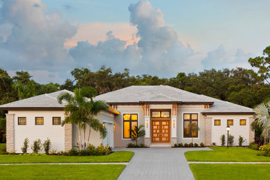 Inspiration for a contemporary one-story house exterior remodel in Tampa with a tile roof