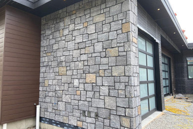 Example of a stone exterior home design in Calgary