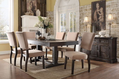 Example of a mid-sized mountain style medium tone wood floor enclosed dining room design in Los Angeles with beige walls, a corner fireplace and a wood fireplace surround
