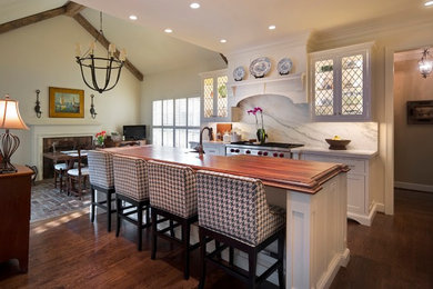 Cottage galley dark wood floor eat-in kitchen photo in Other with shaker cabinets, white cabinets, stainless steel appliances, an island, wood countertops, white backsplash and stone slab backsplash