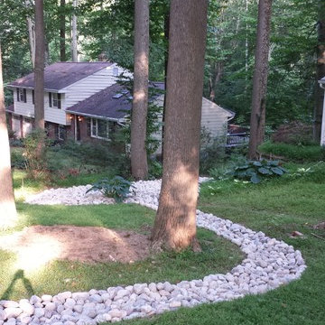 Landscaping and river rock drainage swale