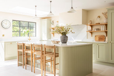 Inspiration for a medium sized kitchen/diner in Other with green cabinets, porcelain flooring, an island and beige floors.
