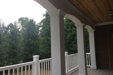 Example of a mid-sized classic backyard deck design in Cincinnati with a roof extension