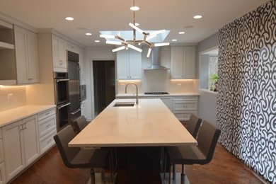 Open concept kitchen - large modern l-shaped medium tone wood floor and brown floor open concept kitchen idea in Chicago with an undermount sink, flat-panel cabinets, dark wood cabinets, quartz countertops, white backsplash, stone slab backsplash, stainless steel appliances and two islands