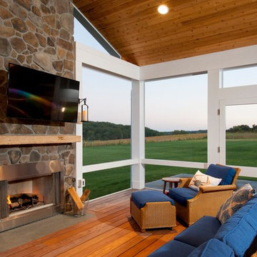 Design Builders screened porch with stone fireplace & Ipe deck in Sykesville MD