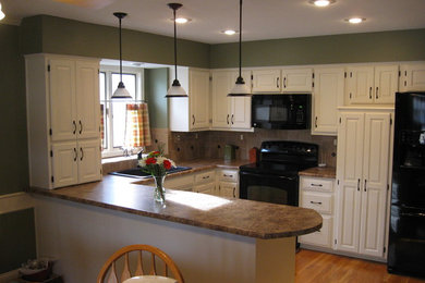 Kitchen - modern brown floor kitchen idea in Kansas City with a drop-in sink, raised-panel cabinets, white cabinets, granite countertops, an island and brown countertops