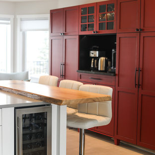Mid-sized transitional l-shaped kitchen pantry in Calgary with an undermount sink, shaker cabinets, white cabinets, quartzite benchtops, white splashback, ceramic splashback, stainless steel appliances, porcelain floors, with island and grey floor.