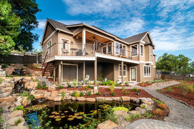 Inspiration for a large transitional beige two-story vinyl gable roof remodel in Other
