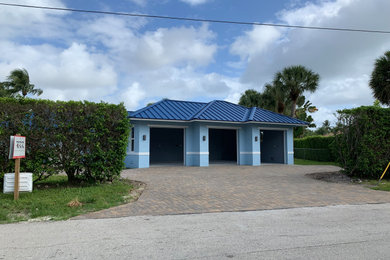 Inspiration for a mid-sized beach style attached three-car garage in Miami.