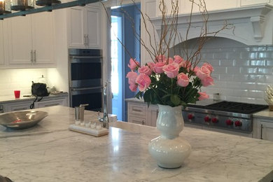 Inspiration for a transitional galley dark wood floor kitchen remodel in Atlanta with a farmhouse sink, shaker cabinets, subway tile backsplash and stainless steel appliances
