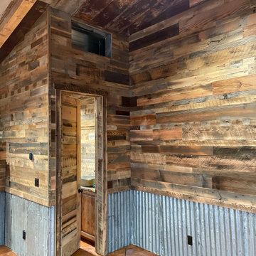 Man Cave- Reclaimed wood walls, rusty metal, barn doors