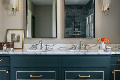 Design ideas for a large traditional ensuite bathroom in Milwaukee with flat-panel cabinets, turquoise cabinets, beige walls, mosaic tile flooring, a submerged sink, marble worktops, white worktops, double sinks and a built in vanity unit.