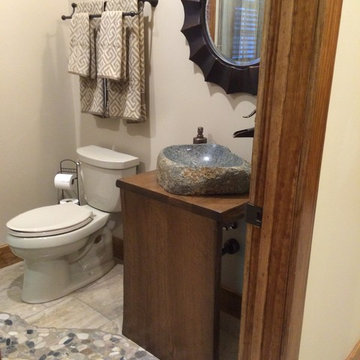 River rock mosaic tile inlay bath floor leads to shower