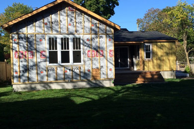 Example of a small classic white one-story wood exterior home design in Toronto