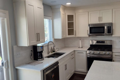 Inspiration for a small transitional u-shaped kitchen remodel in Chicago with shaker cabinets, white cabinets and quartz countertops