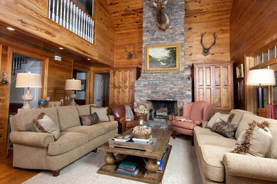 Example of a large cottage formal and enclosed medium tone wood floor living room design in Atlanta with brown walls, a standard fireplace, a stone fireplace and no tv