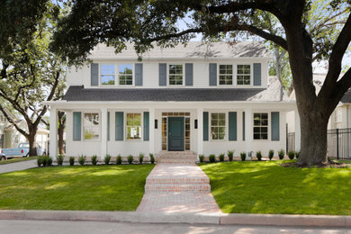 Large traditional two-storey white house exterior in Austin with concrete fiberboard siding, a hip roof, a shingle roof, a grey roof and clapboard siding.