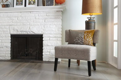 Living room - mid-sized contemporary formal dark wood floor and brown floor living room idea in Miami with blue walls, a standard fireplace and a brick fireplace
