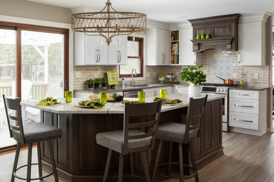 Large transitional vinyl floor and beige floor eat-in kitchen photo in Milwaukee with an undermount sink, raised-panel cabinets, white cabinets, quartz countertops, beige backsplash, ceramic backsplash, stainless steel appliances, an island and beige countertops