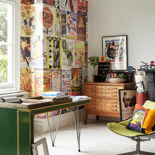 This is an example of an eclectic home studio in London with multi-coloured walls, white floors, painted wood flooring and a freestanding desk.