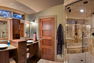 Inspiration for a large timeless master beige tile and porcelain tile travertine floor corner shower remodel in Calgary with a vessel sink, shaker cabinets, medium tone wood cabinets, green walls and granite countertops