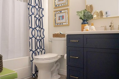 Small beach style bathroom in Other with blue cabinets, a two-piece toilet, white walls, vinyl floors, a drop-in sink, engineered quartz benchtops and grey floor.