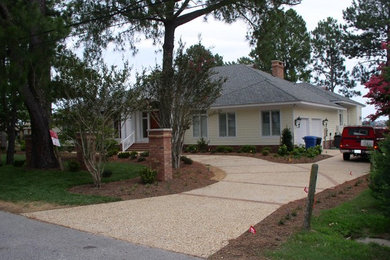 Contemporary yellow one-story concrete fiberboard exterior home idea in Other